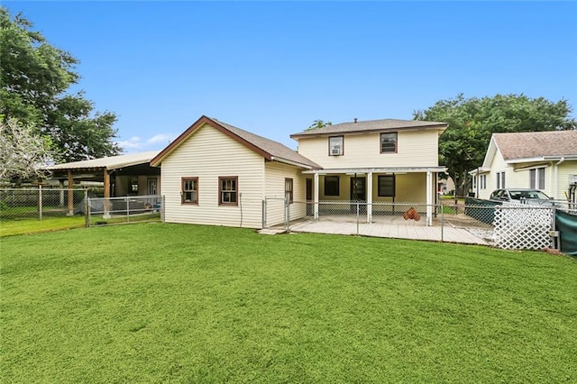 rear view of house featuring a yard and a patio area