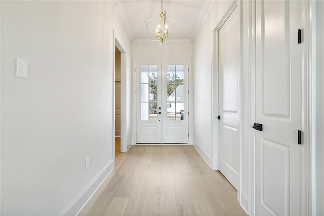 doorway with french doors, light wood-type flooring, an inviting chandelier, and ornamental molding