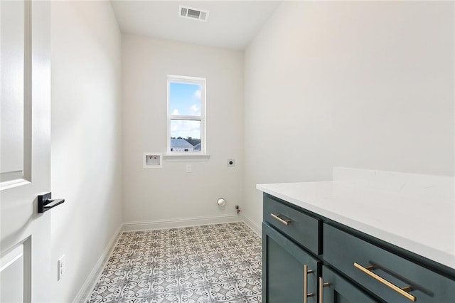 washroom featuring cabinets, washer hookup, hookup for an electric dryer, and hookup for a gas dryer