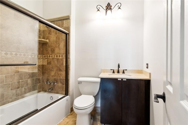 full bathroom featuring shower / bath combination with glass door, tile patterned flooring, vanity, and toilet