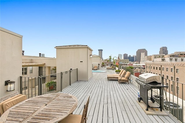 wooden terrace with a grill