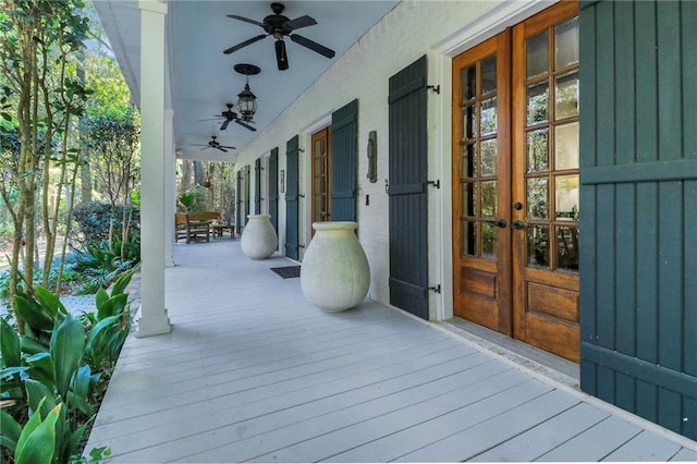 wooden deck featuring ceiling fan, french doors, and a porch