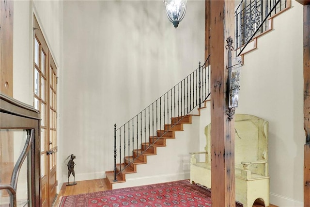 foyer featuring hardwood / wood-style floors and a towering ceiling