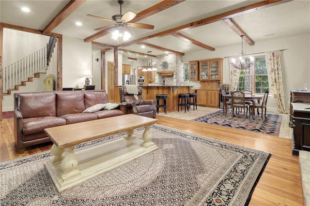 living room with beam ceiling, ceiling fan with notable chandelier, and light hardwood / wood-style flooring