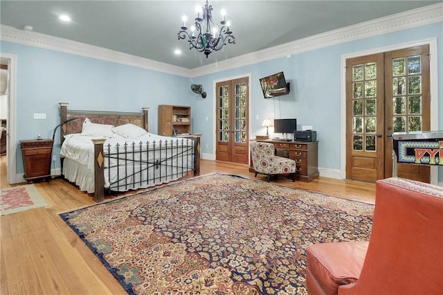 bedroom featuring a chandelier, french doors, crown molding, and hardwood / wood-style floors