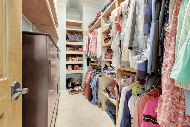 walk in closet with light tile patterned floors