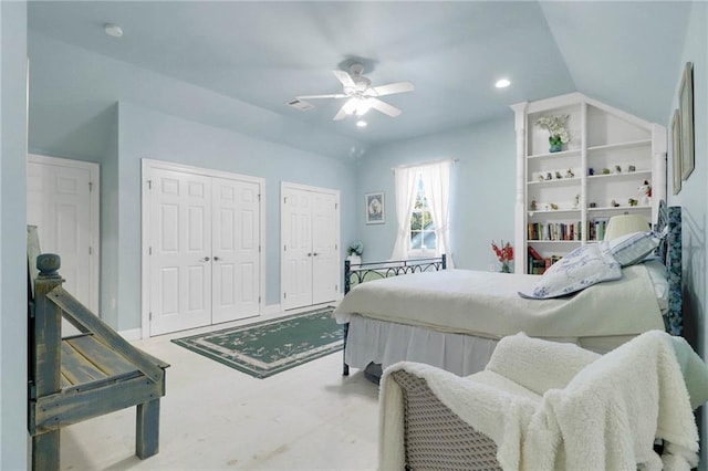 bedroom with ceiling fan, multiple closets, and vaulted ceiling