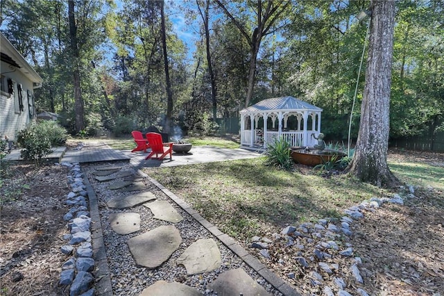 view of yard with a gazebo, a fire pit, and a patio area