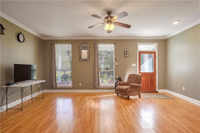 sitting room with light hardwood / wood-style flooring, ceiling fan, and crown molding