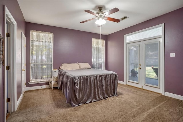 bedroom featuring carpet flooring, multiple windows, and ceiling fan