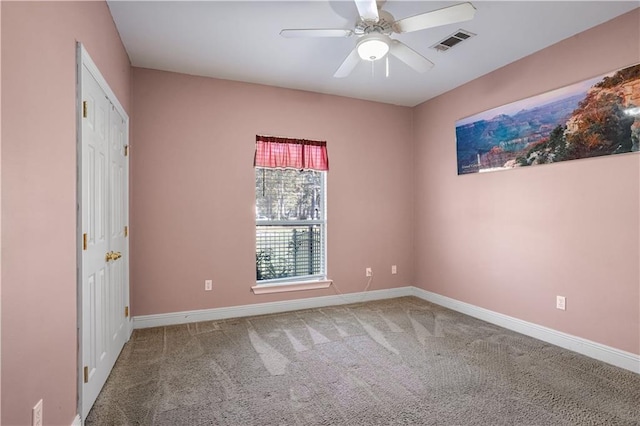 carpeted spare room with ceiling fan