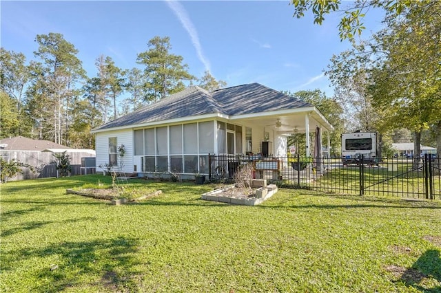 rear view of house with central AC unit, ceiling fan, and a yard