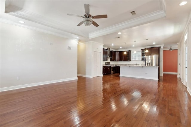 6128 Campus Blvd, New Orleans, LA 70126 - unfurnished living room featuring crown molding, a ceiling fan, dark wood finished floors, recessed lighting, and plenty of natural light