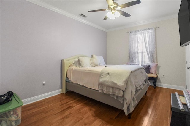 bedroom featuring hardwood / wood-style floors, ceiling fan, and ornamental molding