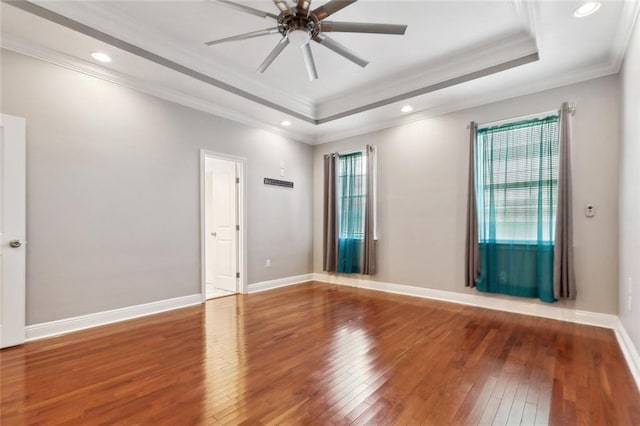 6128 Campus Blvd, New Orleans, LA 70126 - spare room featuring healthy amount of natural light, a tray ceiling, a ceiling fan, hardwood / wood-style flooring, and ornamental molding