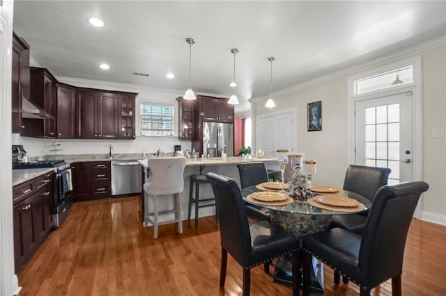 dining space with crown molding and dark wood-type flooring