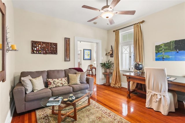 living room with hardwood / wood-style flooring and ceiling fan