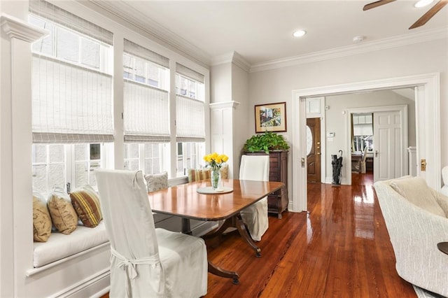 dining room with dark hardwood / wood-style floors, ceiling fan, and ornamental molding