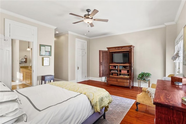 bedroom featuring hardwood / wood-style floors, ensuite bath, ceiling fan, and ornamental molding