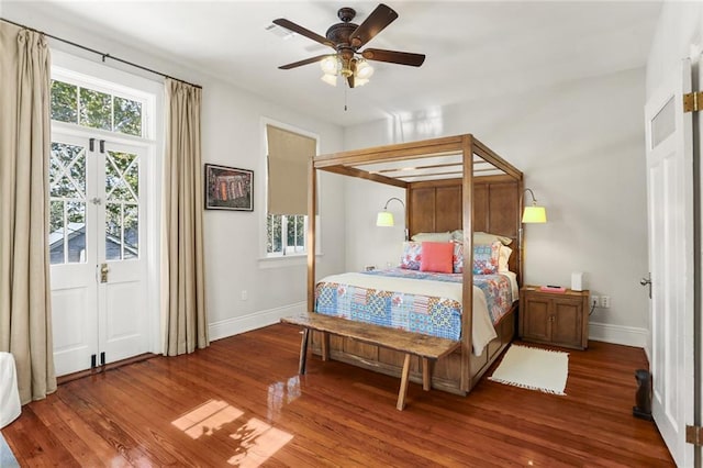 bedroom featuring ceiling fan, hardwood / wood-style floors, and french doors