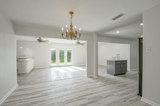 interior space featuring ceiling fan with notable chandelier, light wood-type flooring, and french doors