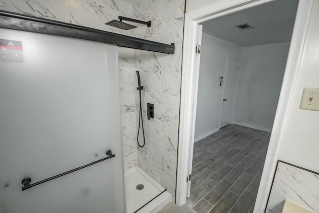 bathroom featuring hardwood / wood-style flooring and a shower with shower door