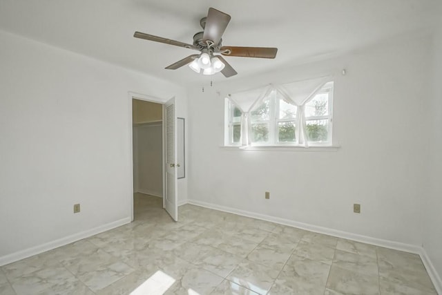 unfurnished bedroom with ceiling fan and a closet