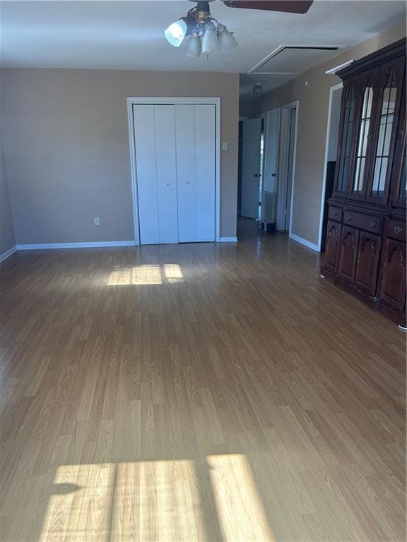 interior space with hardwood / wood-style floors and ceiling fan