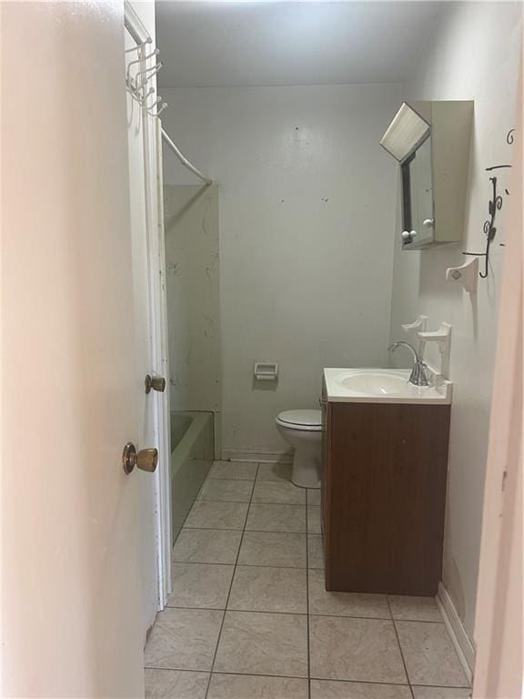 bathroom featuring tile patterned flooring, vanity, and toilet