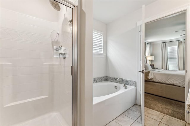 bathroom with plus walk in shower, tile patterned floors, and plenty of natural light