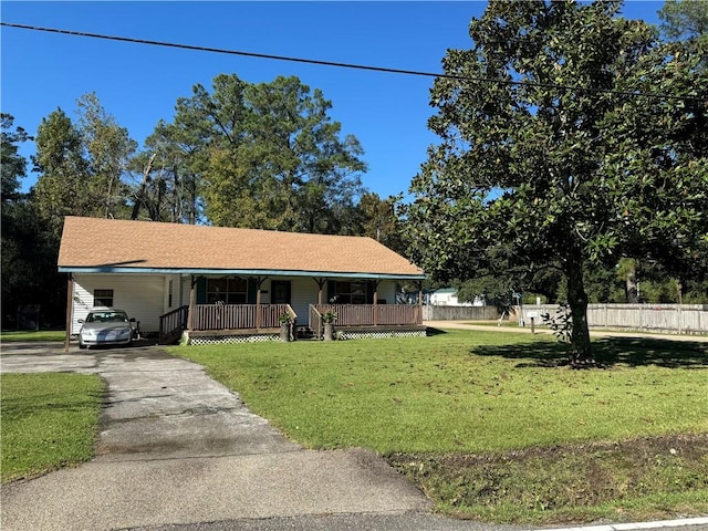 view of front of home with a carport, covered porch, and a front yard