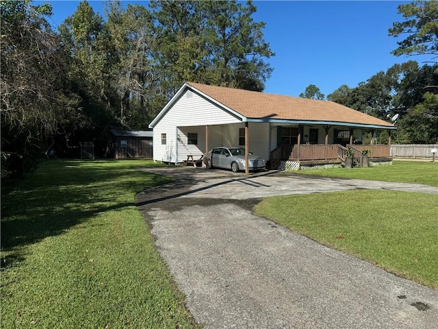 ranch-style home featuring a front yard, a porch, and a carport