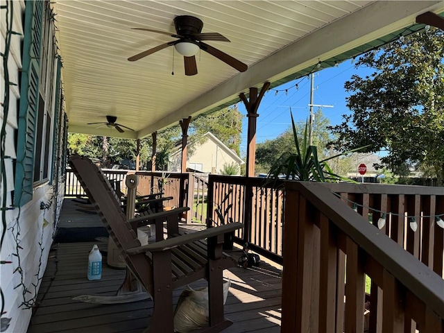 wooden terrace with ceiling fan and covered porch