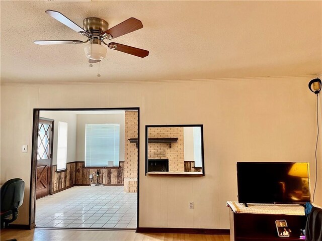 kitchen with white fridge, ceiling fan, ornamental molding, tile counters, and dark brown cabinets