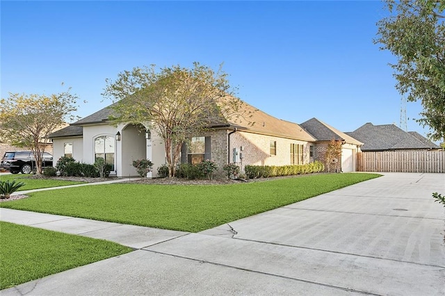 view of front of home with a front lawn and a garage