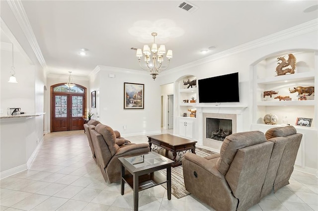 tiled living room with built in shelves, crown molding, french doors, and a notable chandelier