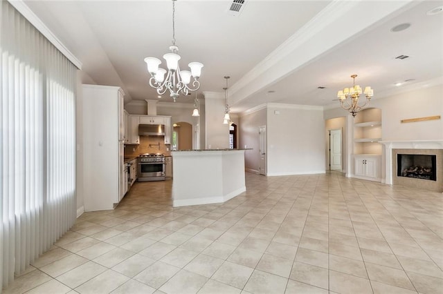 kitchen featuring light tile patterned floors, open floor plan, high end stainless steel range oven, and a chandelier