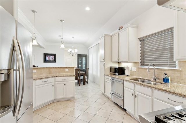 kitchen with light tile patterned floors, tasteful backsplash, a sink, appliances with stainless steel finishes, and an inviting chandelier