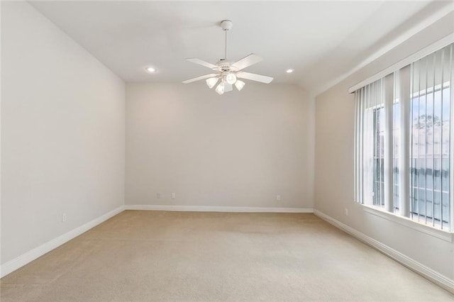 empty room featuring a healthy amount of sunlight, a ceiling fan, recessed lighting, and light carpet