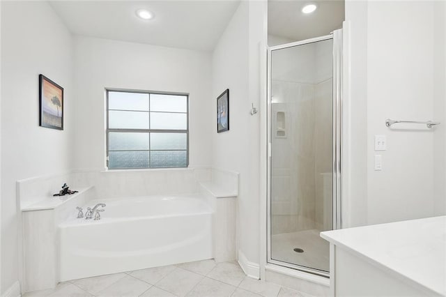 bathroom featuring a garden tub, recessed lighting, tile patterned flooring, and a shower stall