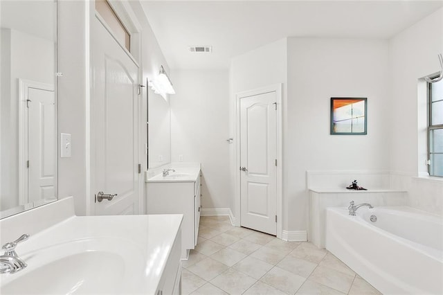 bathroom featuring tile patterned floors, two vanities, a sink, visible vents, and a garden tub
