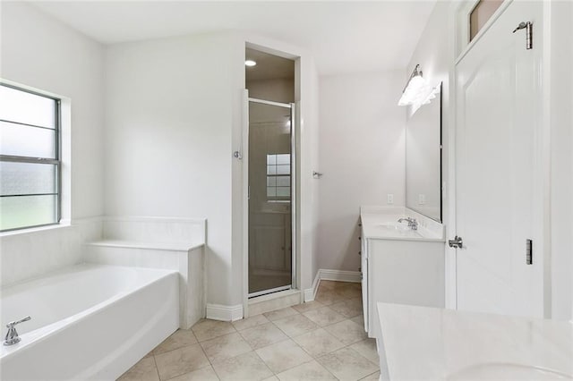 full bath with baseboards, a stall shower, a bath, and vanity
