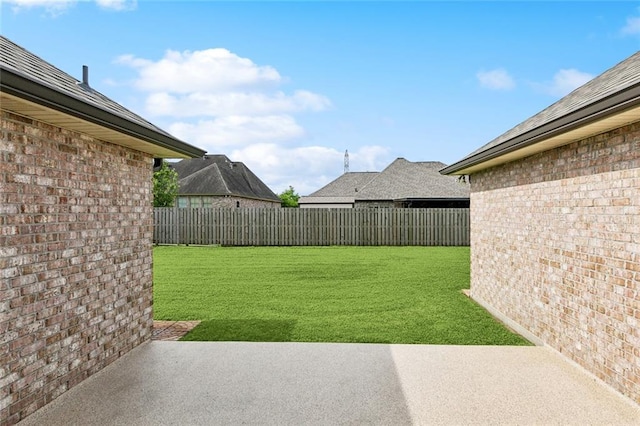 view of yard with a patio area and a fenced backyard