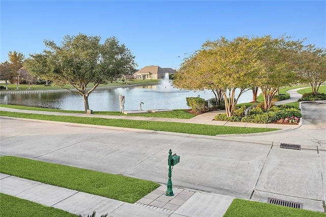 view of community with visible vents and a water view