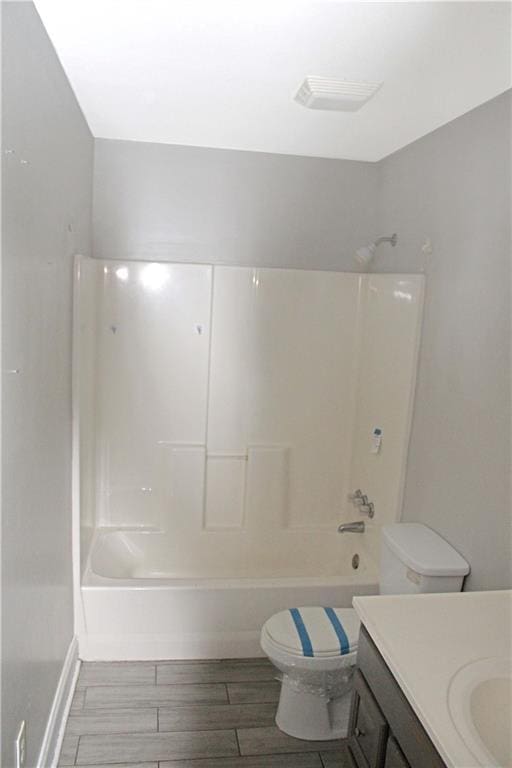 full bathroom with wood-type flooring, vanity, toilet, and shower / tub combination