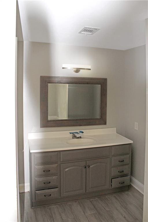 bathroom with hardwood / wood-style floors and vanity