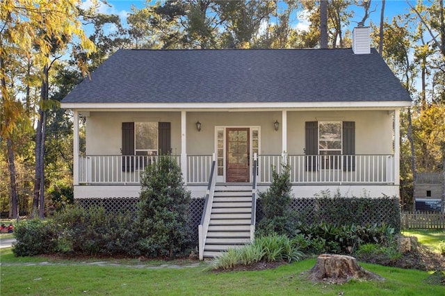 bungalow featuring a porch and a front lawn