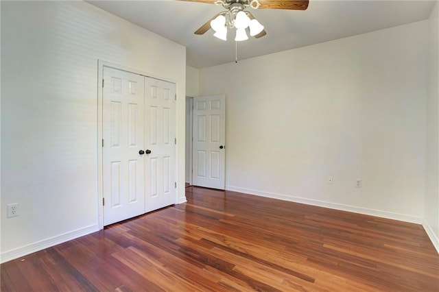 unfurnished bedroom featuring a closet, ceiling fan, and dark hardwood / wood-style flooring