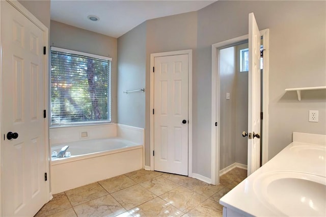 bathroom featuring a tub and vanity