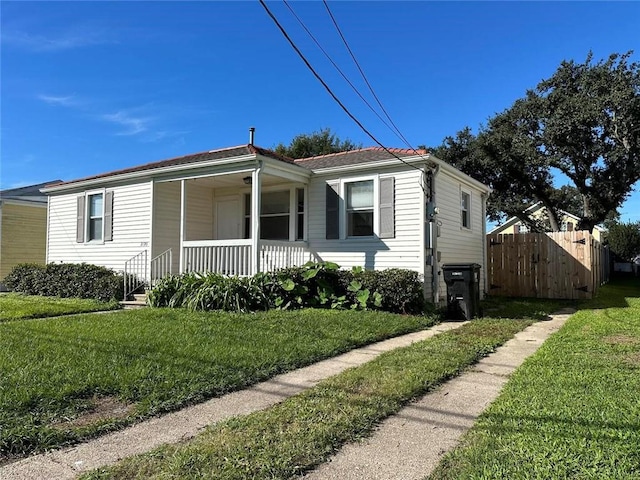 view of front of house with a front yard and a porch